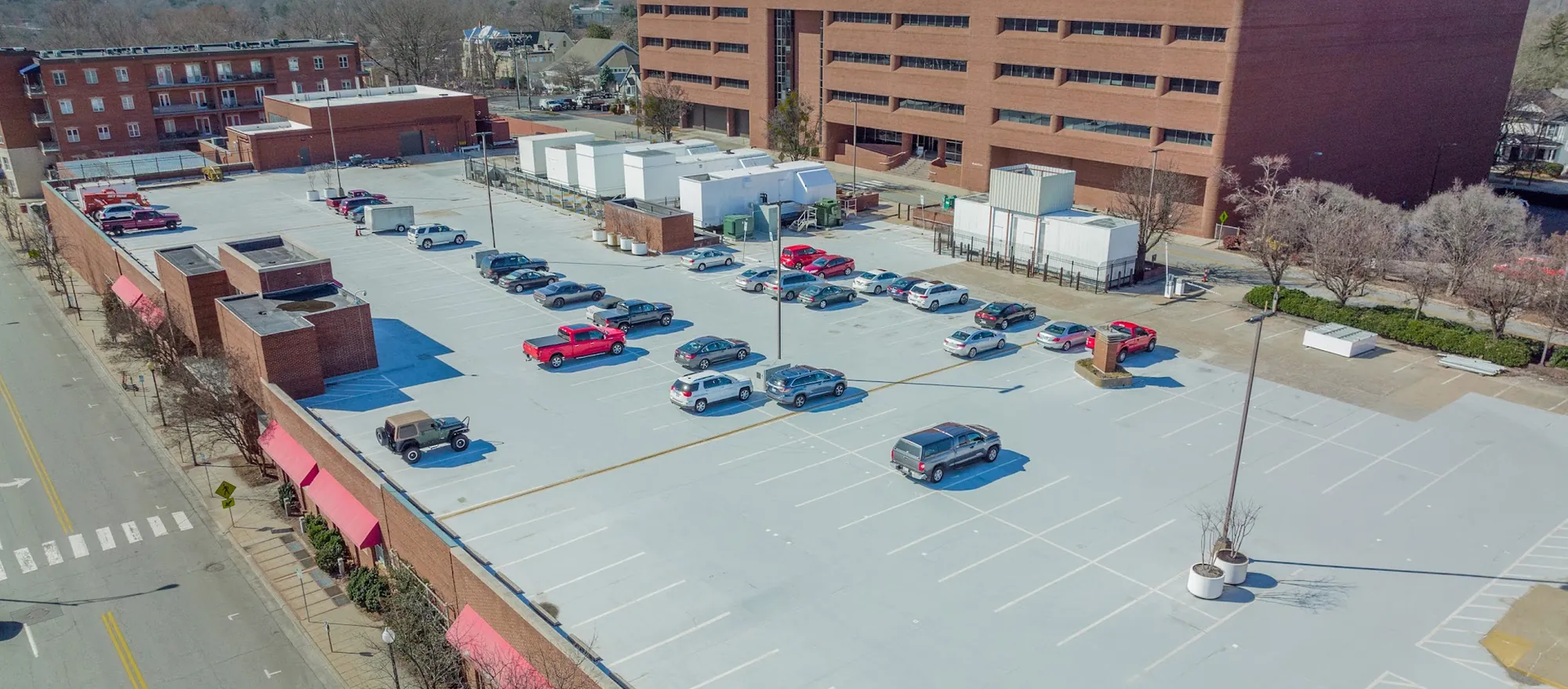 The Annex rooftop parking deck with mechanical plant along its north edge and the West End Center main building rising behind it